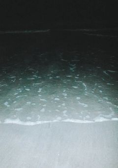 夜の海沿いの小さな家